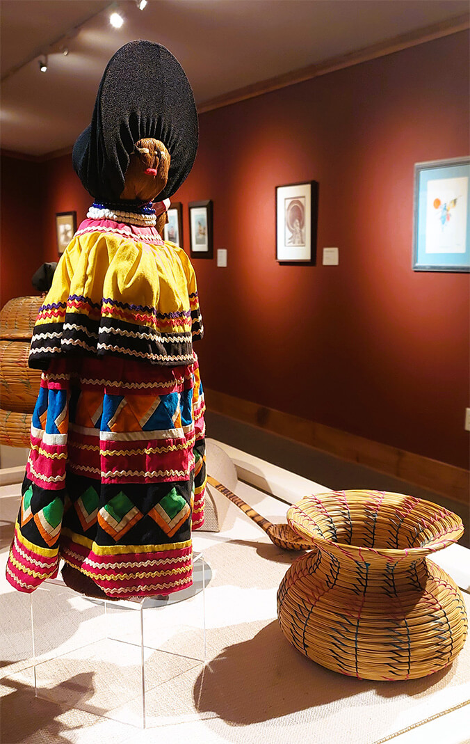 A wicker sculpture and colorful figure on display as a part of the Seminole Signatures collection.