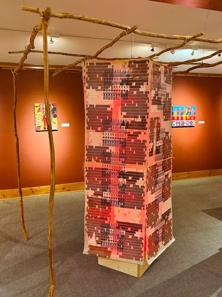 Tony A. Tiger (Oklahoma Seminole/Muscogee/Sac & Fox) – Community Arbor: Time and Place Young pecan trees, ink, printed mulberry paper, copper wire, artificial sinew, LED light, wax 2025